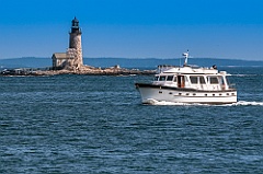 Boat Passes by Halfway Rock Lighthouse in Maine